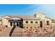 A charming single-Gathering house featuring a stone facade, desert landscaping, and a well-manicured front yard at 19910 W Mulberry Dr, Buckeye, AZ 85396