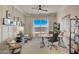Bright home office with stylish decor, a large window offering natural light, and comfortable seating creates a productive workspace at 19910 W Mulberry Dr, Buckeye, AZ 85396