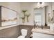Stylish powder room with modern fixtures, decorative wall art, and a sleek vanity at 19910 W Mulberry Dr, Buckeye, AZ 85396