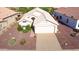 Aerial view of a charming single-story home with a well-maintained landscape and driveway at 19961 N Coyote Lakes Pkwy, Surprise, AZ 85378