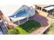 Picture of a backyard with a covered patio, rock landscaping, and a lush green lawn at 19961 N Coyote Lakes Pkwy, Surprise, AZ 85378