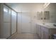 Bathroom featuring a glass shower, double sinks, and tile floor at 19961 N Coyote Lakes Pkwy, Surprise, AZ 85378