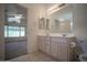 Bright bathroom with double sinks, and views to the bedroom at 19961 N Coyote Lakes Pkwy, Surprise, AZ 85378
