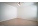 Tiled floor bedroom with ceiling fan and natural light at 19961 N Coyote Lakes Pkwy, Surprise, AZ 85378