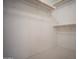 Walk-in closet with adjustable shelving at 19961 N Coyote Lakes Pkwy, Surprise, AZ 85378