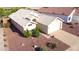 Aerial view of a single Gathering home with desert landscaping, tile roof and attached two car garage at 19961 N Coyote Lakes Pkwy, Surprise, AZ 85378