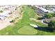 Aerial view of a green golf course featuring sand traps with houses in the distance at 19961 N Coyote Lakes Pkwy, Surprise, AZ 85378