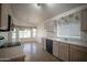 Bright kitchen with white cabinets, tile floors and dining area with lots of windows at 19961 N Coyote Lakes Pkwy, Surprise, AZ 85378