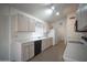 Bright kitchen with white cabinets, modern appliances and tile floors at 19961 N Coyote Lakes Pkwy, Surprise, AZ 85378