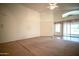 Bright and airy living room with carpet and patio access at 19961 N Coyote Lakes Pkwy, Surprise, AZ 85378