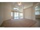Open-concept living room with vaulted ceilings and neutral carpeting at 19961 N Coyote Lakes Pkwy, Surprise, AZ 85378