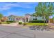 Charming single story home with manicured lawn and shrubbery under a clear blue sky at 20115 E Sonoqui E Blvd, Queen Creek, AZ 85142