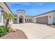 Single story home featuring a circular entryway, manicured landscaping, and a spacious driveway at 20115 E Sonoqui E Blvd, Queen Creek, AZ 85142