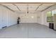 Spacious two-car garage featuring epoxy flooring and ample storage space at 20115 E Sonoqui E Blvd, Queen Creek, AZ 85142