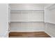 Spacious walk-in closet with wood-look flooring and ample shelving for optimal storage solutions at 20115 E Sonoqui E Blvd, Queen Creek, AZ 85142