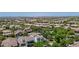 An aerial view of the home nestled in a vibrant community, landscaped with mature trees and shrubs at 20437 W White Rock Rd, Buckeye, AZ 85396
