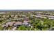 An aerial view of the home nestled in a vibrant community, landscaped with mature trees and shrubs at 20437 W White Rock Rd, Buckeye, AZ 85396