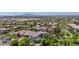 An aerial view of the home nestled in a vibrant community, landscaped with mature trees and shrubs at 20437 W White Rock Rd, Buckeye, AZ 85396