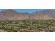 Neighborhood aerial view of a vibrant community nestled against picturesque desert mountains and blue skies at 20437 W White Rock Rd, Buckeye, AZ 85396