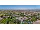 An aerial view of the home nestled in a vibrant community, landscaped with mature trees and shrubs at 20437 W White Rock Rd, Buckeye, AZ 85396
