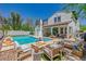 Inviting backyard with pool, fire pit, covered patio, and lush greenery creates a relaxing and entertaining outdoor space at 20437 W White Rock Rd, Buckeye, AZ 85396