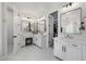 Bright bathroom featuring vanities, mirrors, and closet with clothing at 20437 W White Rock Rd, Buckeye, AZ 85396