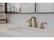 Close-up on bathroom sink featuring modern brushed gold fixtures and white counter at 20437 W White Rock Rd, Buckeye, AZ 85396
