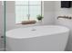 Close up of a free-standing tub in a bright bathroom with neutral decor at 20437 W White Rock Rd, Buckeye, AZ 85396