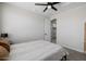 This bedroom features neutral walls, carpet, ceiling fan and an adjoining room with white cabinets at 20437 W White Rock Rd, Buckeye, AZ 85396