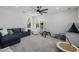 A bonus room features plush carpet, ceiling fan, neutral paint, natural light, and seating at 20437 W White Rock Rd, Buckeye, AZ 85396