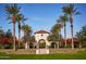 Grand community entrance framed by palm trees, featuring decorative architecture and manicured landscaping at 20437 W White Rock Rd, Buckeye, AZ 85396
