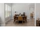Bright dining area features modern decor, wood floors, and ample natural light for a cozy and elegant feel at 20437 W White Rock Rd, Buckeye, AZ 85396