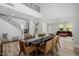 Elegant dining area showcases a modern table set, complemented by a staircase and entry to the living room at 20437 W White Rock Rd, Buckeye, AZ 85396