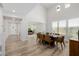 Open-concept dining area with high ceilings, wood floors, and seamless flow to the living room, great for gatherings at 20437 W White Rock Rd, Buckeye, AZ 85396