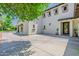 Angle view of a charming two-story home featuring stucco, arched porch, and paved driveway at 20437 W White Rock Rd, Buckeye, AZ 85396