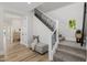 Welcoming entryway with staircase, bench, and wood floors, combining style with functionality and storage space at 20437 W White Rock Rd, Buckeye, AZ 85396
