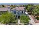 Aerial view of a two-story home featuring lush landscaping, a well manicured lawn and a beautiful exterior at 20437 W White Rock Rd, Buckeye, AZ 85396