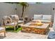 Relaxing patio seating area features a stone fire pit, ideal for cozy evenings and outdoor entertaining at 20437 W White Rock Rd, Buckeye, AZ 85396