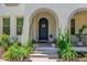 Inviting front entrance featuring a dark wood door with a floral wreath and tasteful landscaping at 20437 W White Rock Rd, Buckeye, AZ 85396