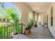 A spacious porch with potted plants and wrought iron railings offers a view of the well-maintained neighborhood at 20437 W White Rock Rd, Buckeye, AZ 85396
