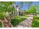 Charming two-story home featuring stucco, arched porch, and beautifully landscaped yard at 20437 W White Rock Rd, Buckeye, AZ 85396