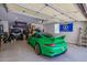 View of garage containing a green Porsche, UTV, storage and flags at 20437 W White Rock Rd, Buckeye, AZ 85396