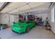 View of garage containing a green Porsche, storage and other items at 20437 W White Rock Rd, Buckeye, AZ 85396