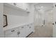 Bright hallway with custom built-in cabinets and drawers plus stairway access to upper level at 20437 W White Rock Rd, Buckeye, AZ 85396