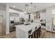 Open kitchen with island, stainless appliances, wood floors and pendant lights at 20437 W White Rock Rd, Buckeye, AZ 85396