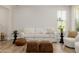 Bright living room with couch, ottomans and hardwood floors at 20437 W White Rock Rd, Buckeye, AZ 85396