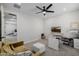 Comfortable living room or office space with versatile furniture, a ceiling fan and modern design elements at 20437 W White Rock Rd, Buckeye, AZ 85396