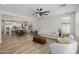 Open concept living room with kitchen in background and hardwood floors at 20437 W White Rock Rd, Buckeye, AZ 85396
