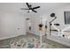 Bright office with a ceiling fan, stylish rug, and a standing desk at 20437 W White Rock Rd, Buckeye, AZ 85396