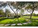 Serene park setting with gazebo, mature trees, lush lawn, and walking path at 20437 W White Rock Rd, Buckeye, AZ 85396